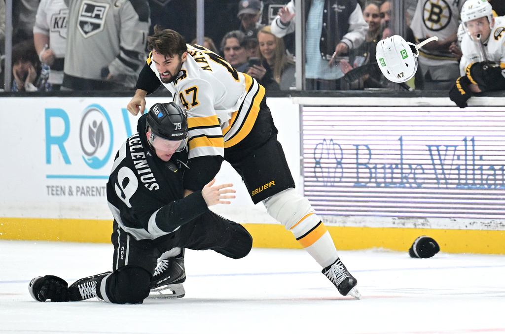 Boston Bruins center Mark Kastelic (47) fights with Los Angeles Kings center Samuel Helenius (79) during the first period of an NHL hockey game Saturday, Oct. 17, 2026, in Los Angeles. (AP Photo/Wally Skalij)