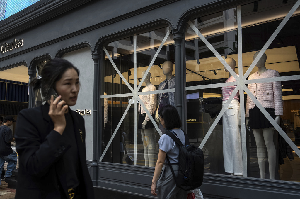 Taped-up windows are seen at a retail store ahead of Super Typhoon Ragasa approaches Hong Kong, Tuesday, Sept. 23, 2025. (AP Photo/Chan Long Hei)