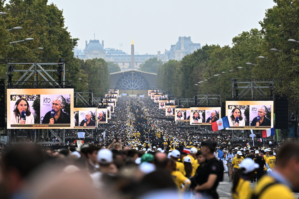 People wait for Pope Leo XIV on the Champs Elysees avenue before a mass at Place de la Concorde in Paris, Saturday, Sept. 26, 2026. (AP Photo/Emma Da Silva)