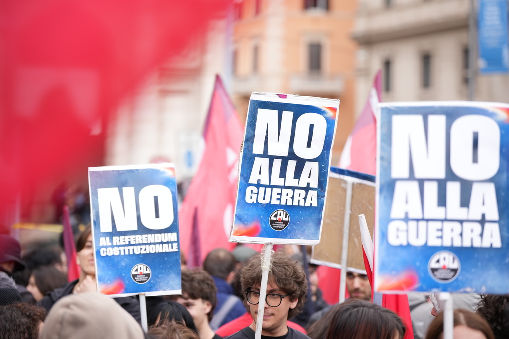 People hold banners reading 'No to war' as they take part in a national demonstration against the war in Iran and the March 22 referendum on the Italian justice system, in Rome, Saturday, March 14 2026. (AP Photo/Andrew Medichini)