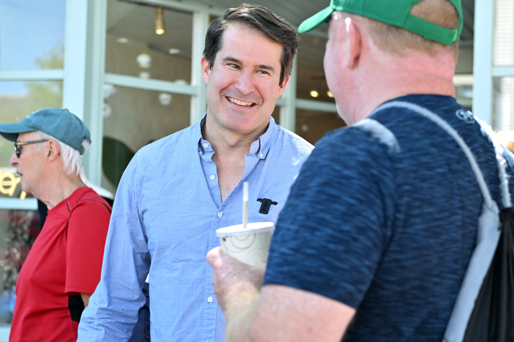 U.S. Rep. Seth Moulton, D-Mass. who is campaigning to unseat Sen. Ed Markey, D-Mass., speaks to prospective voters Saturday, Aug. 29, 2026, in Wakefield, Mass. (AP Photo/Josh Reynolds)