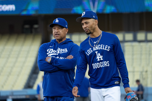 Los Angeles Dodgers manager Dave Roberts, left, talks with Mookie Betts during practice Tuesday, Oct. 7, 2025, in Los Angeles, the day before Game 3 of baseball's National League Division Series against the Philadelphia Phillies. (AP Photo/Jae C. Hong) Los Angeles Dodgers manager Dave Roberts, left, talks with Mookie Betts during practice Tuesday, Oct. 7, 2025, in Los Angeles, the day before Game 3 of baseball's National League Division Series against the Philadelphia Phillies. (AP Photo/Jae C. Hong)