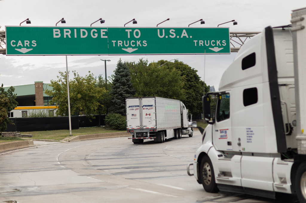 Transport trucks cross the Ambassador Bridge into the United States of America, in Windsor, Ontario, Canada, Saturday, Aug. 22, 2026. (Dax Melmer/The Canadian Press via AP)