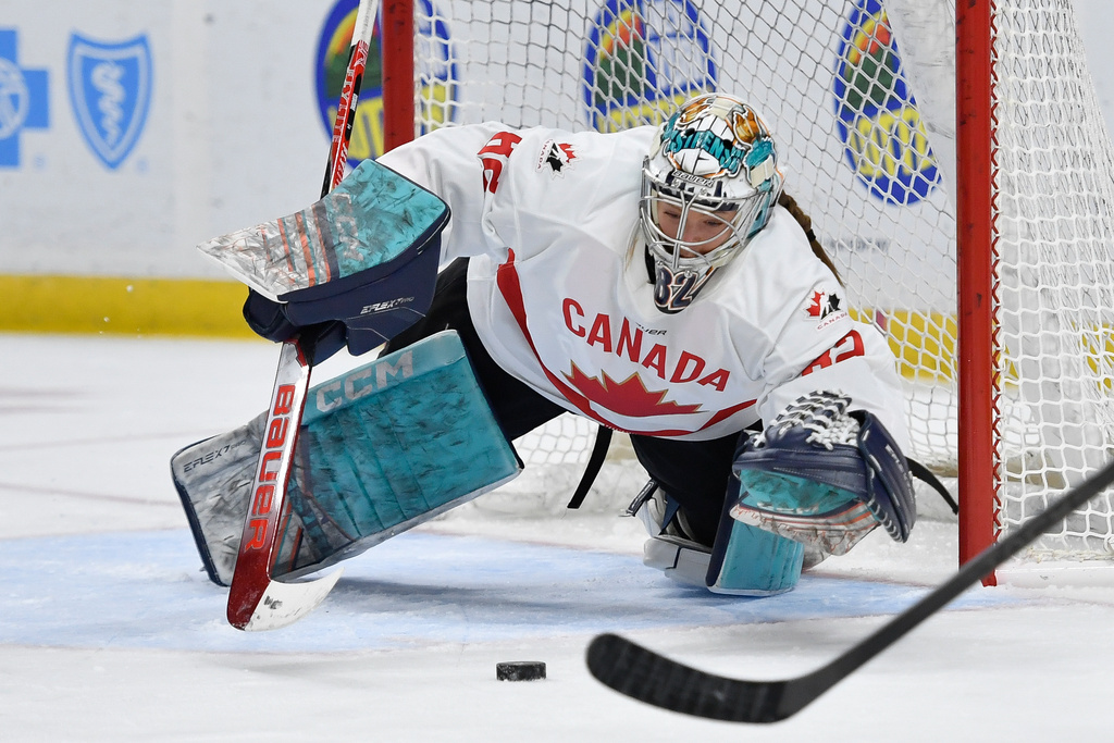 Canada goalie Kayle Osborne (82) dives for a loose puck during the first period of a Rivalry Series women's hockey game against the United States, Saturday, Nov. 8, 2025, in Buffalo, N.Y. (AP Photo/Adrian Kraus)