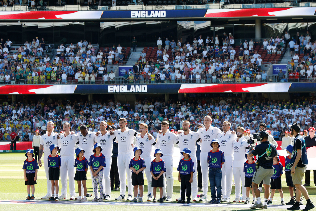England players line up for the national anthem during play on day one of the third Ashes cricket test between England and Australia at the Adelaide Oval in Adelaide, Australia, Wednesday, Dec. 17, 2025. (AP Photo/James Elsby)