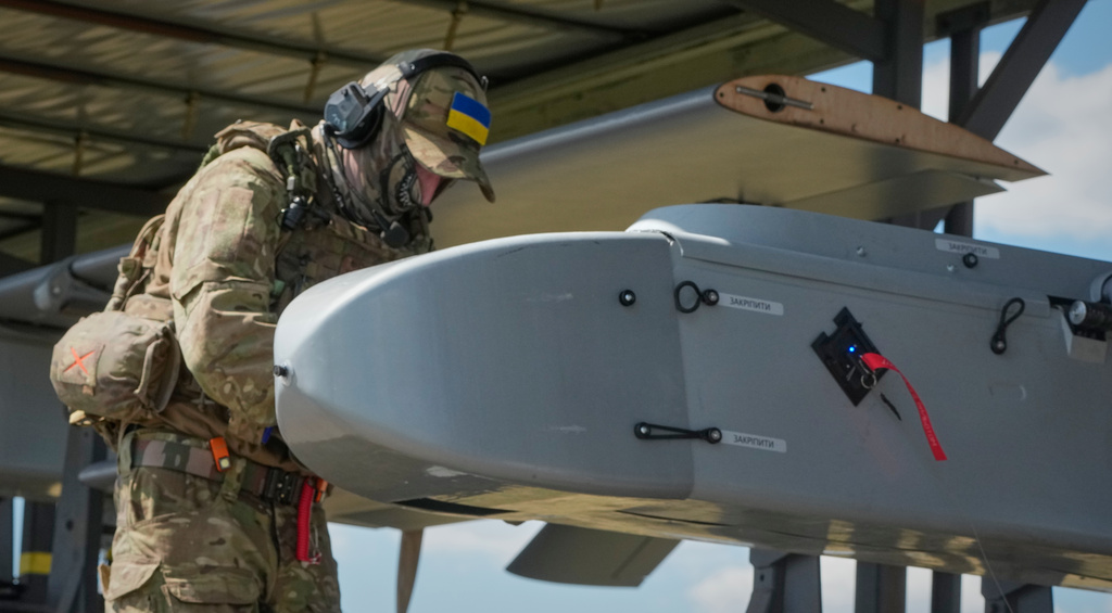 A soldier of Ukraine's 413th Separate Regiment of Unmanned Systems "Raid" prepares an FP-1 long-range attack drone to be launched on a deep-strike drone mission to hit Russian targets deep in their territory, in an undisclosed location in Ukraine, Sunday, Aug. 16, 2026. (AP Photo/Efrem Lukatsky)