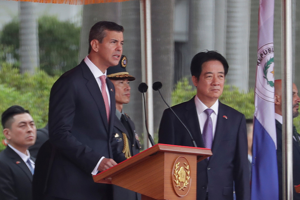 Paraguayan President Santiago Pena, left, accompanied by Taiwan President Tsai Ing-wen, delivers a speech during a military welcome ceremony in Taipei, Taiwan, Friday, May 8, 2026. (AP Photo/Chiang Ying-ying)