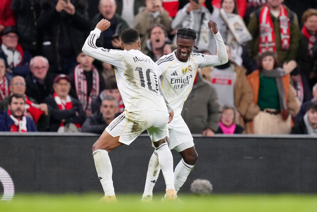 Real Madrid's Eduardo Camavinga, right, celebrates with Real Madrid's Kylian Mbappe after scoring his side's second goal during the Spanish La Liga soccer match between Athletic Bilbao and Real Madrid in Bilbao, Spain, Wednesday, Dec. 3, 2025. (AP Photo/Jose Breton)