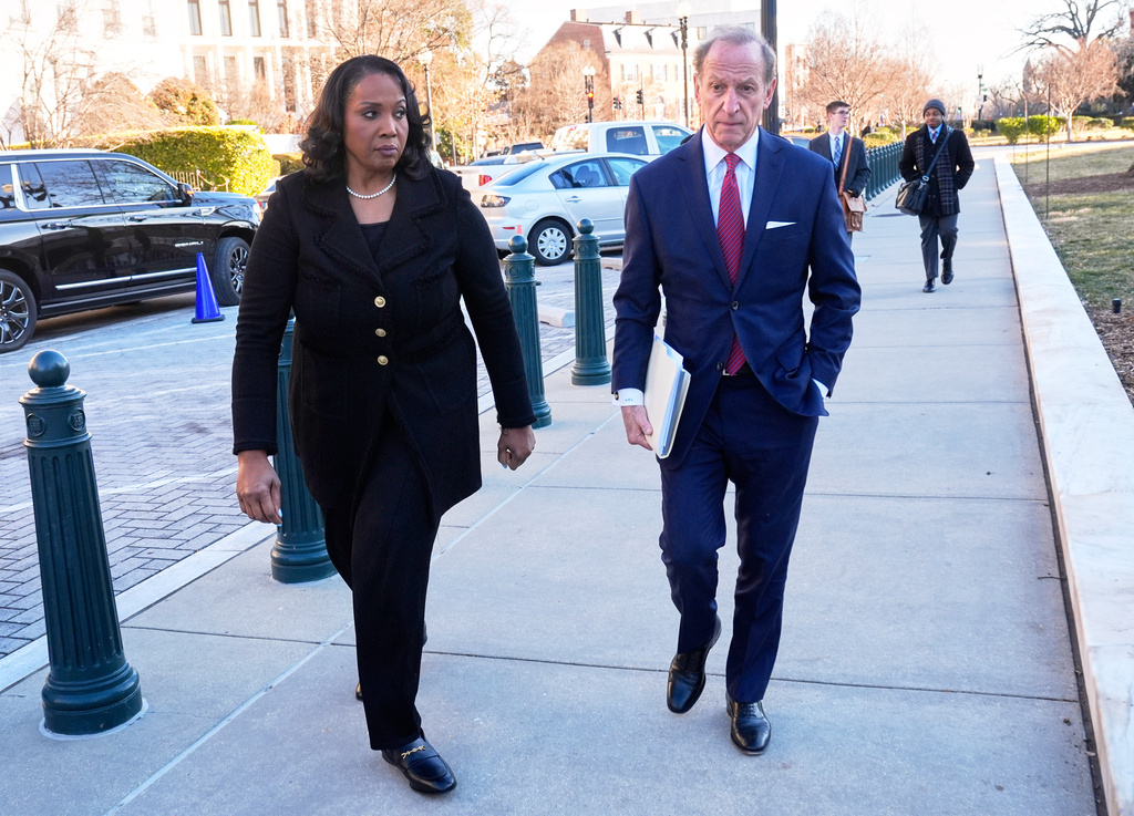 Federal Reserve governor Lisa Cook and attorney Abbe Lowell, arrive at the Supreme Court in Washington, Wednesday, Jan. 21, 2026. (AP Photo/Mark Schiefelbein)