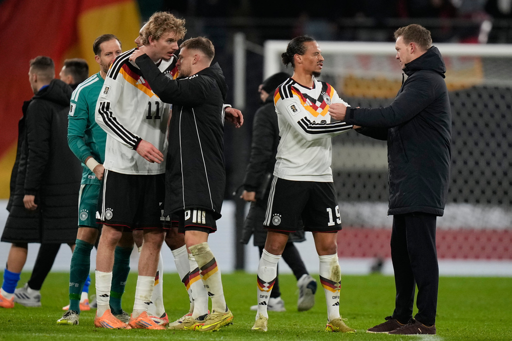 Germany's coach Julian Nagelsmann congratulates Leroy Sané after a group A World Cup qualifiying soccer match between Germany and Slovakia in Leipzig, Germany, Monday, Nov. 17, 2025. (AP Photo/Matthias Schrader)