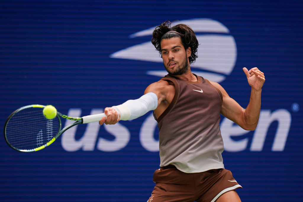 Carlos Alcaraz, of Spain, returns the ball to Roman Safiullin, of Russia, during the first round of the U.S. Open tennis championships, Monday, Aug. 31, 2026, in New York. (AP Photo/Seth Wenig)