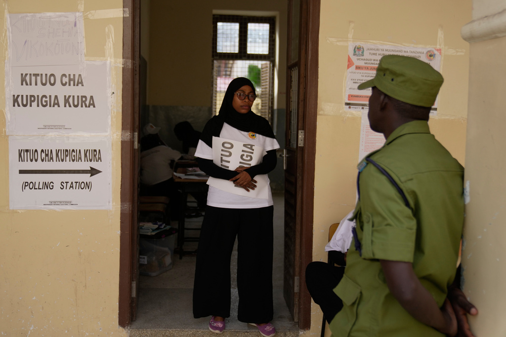A police officer stands at the door during the counting of votes at Haile Selassie polling station in Zanzibar, Tanzania, Wednesday, Oct. 29, 2025. (AP Photo/Brian Inganga)