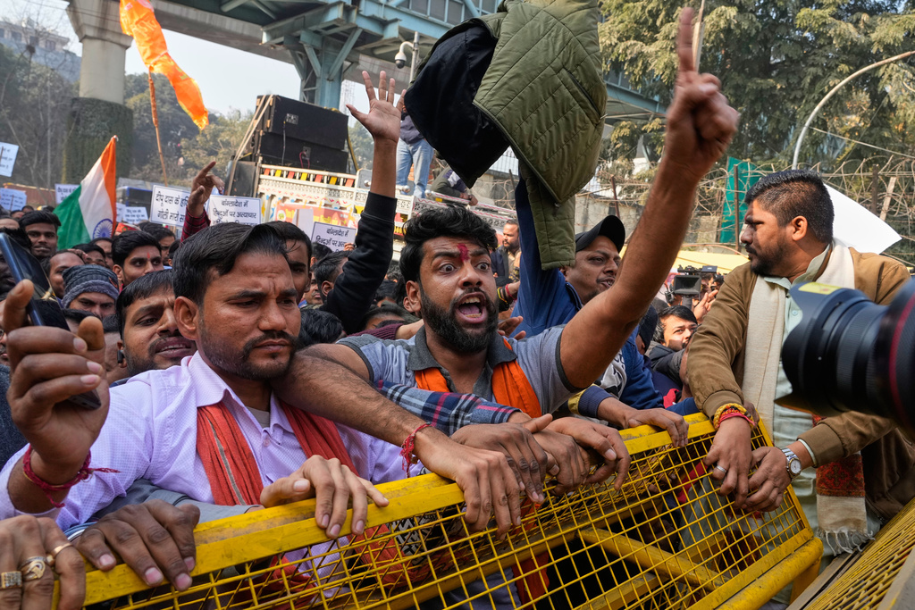 Activists of Vishwa Hindu Parishad, a prominent right-wing Hindu nationalist organization, shout slogans during a protest near Bangladesh High Commission accusing Bangladeshi groups of wrongly targeting Indians, in New Delhi, India, Tuesday, Dec.23, 2025. (AP Photo/Manish Swarup)