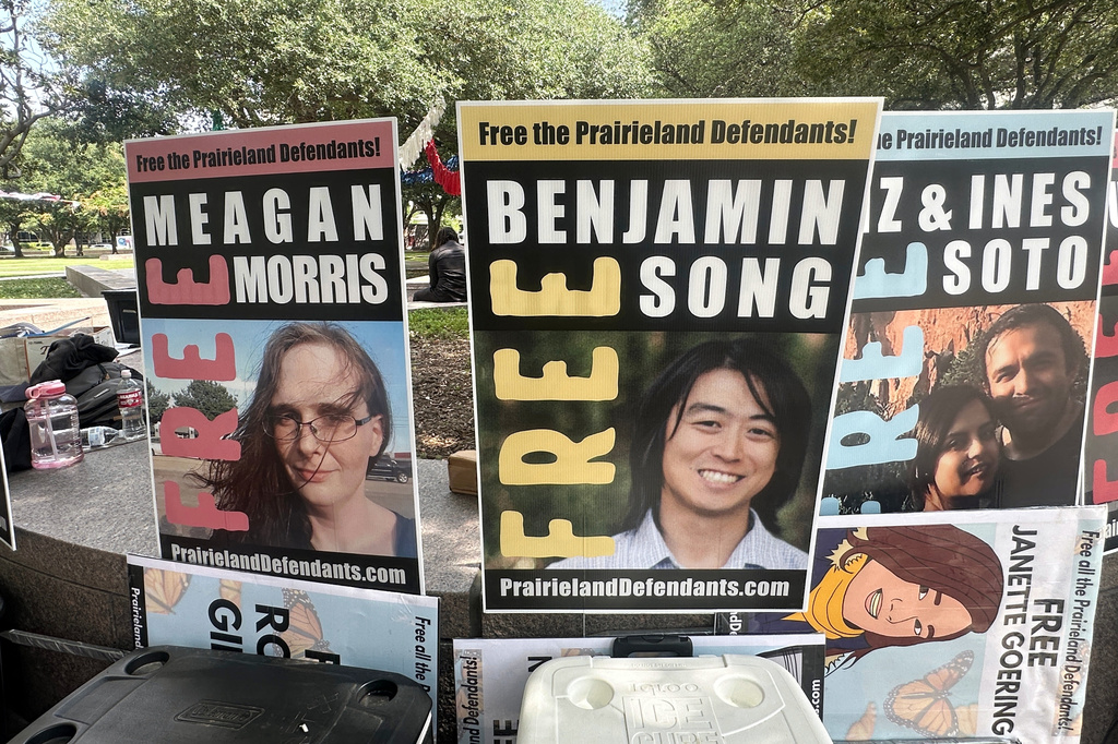 Supporters of protesters convicted over a shooting outside a Texas immigration detention center display signs in support of the defendants outside a federal courthouse in Fort Worth, Texas on Tuesday, June 23, 2026. (AP Photo/Kendria LaFleur)