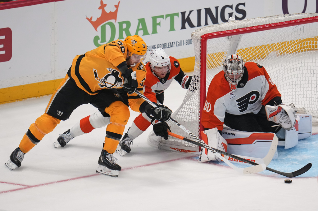 Pittsburgh Penguins' Anthony Mantha (39) can't get off a shot with Philadelphia Flyers' Cam York (8) defending in front of goaltender Dan Vladar (80) during the first period of Game 1 in the first round of the NHL Stanley Cup playoffs in Pittsburgh, Saturday, April 18, 2026. (AP Photo/Gene J. Puskar)