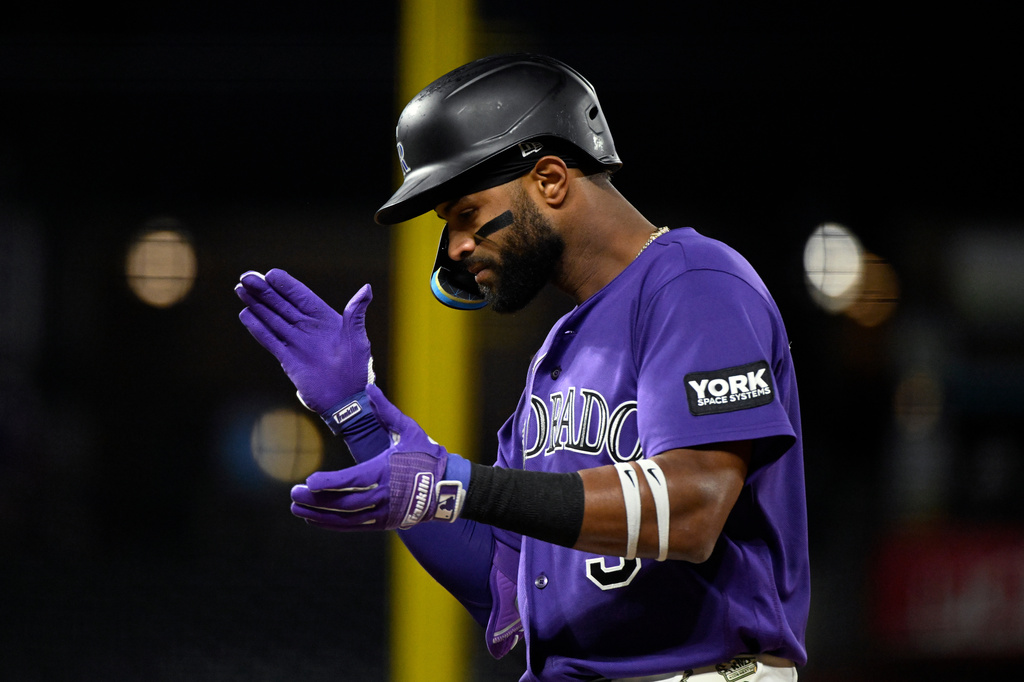Colorado Rockies' Willi Castro claps after hitting an RBI-single in the fifth inning of a baseball game against the Houston Astros, Monday, April 6, 2026, in Denver. (AP Photo/Geneva Heffernan)