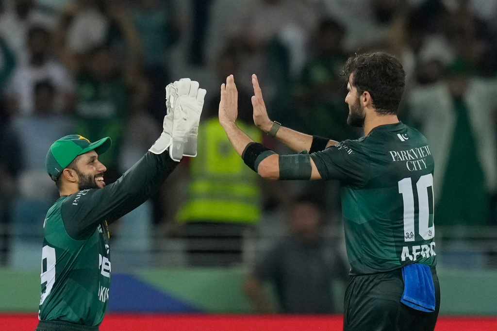 Pakistan's Shaheen Shah Afridi, right, celebrates the dismissal of Bangladesh's Shamim Hossain during the Asia Cup cricket match between Bangladesh and Pakistan at Dubai International Cricket stadium in Dubai, United Arab Emirates, Thursday, Sept. 25, 2025. (AP Photo/Altaf Qadri)