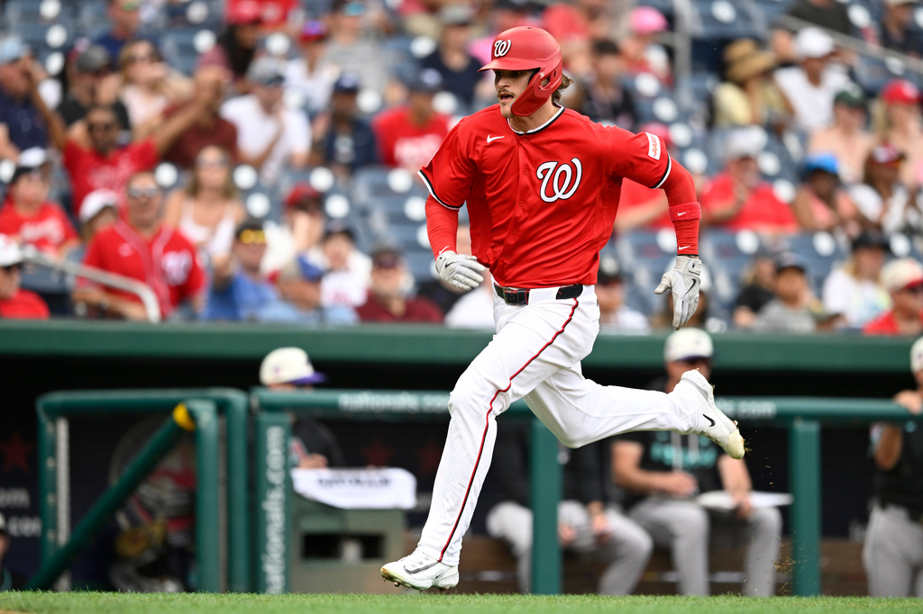 Washington Nationals' Brady House scores a run on a Nationals' Jacob Young RBI single during the second inning of a baseball game against the Arizona Diamondbacks, Sunday, July 26, 2026, in Washington. (AP Photo/John McDonnell)