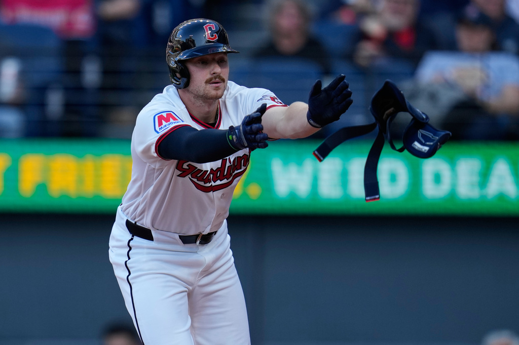 Cleveland Guardians' Kyle Manzardo tossers his leg protector after walking in the first inning of a baseball game against the Baltimore Orioles in Cleveland, Thursday, April 16, 2026. (AP Photo/Sue Ogrocki)