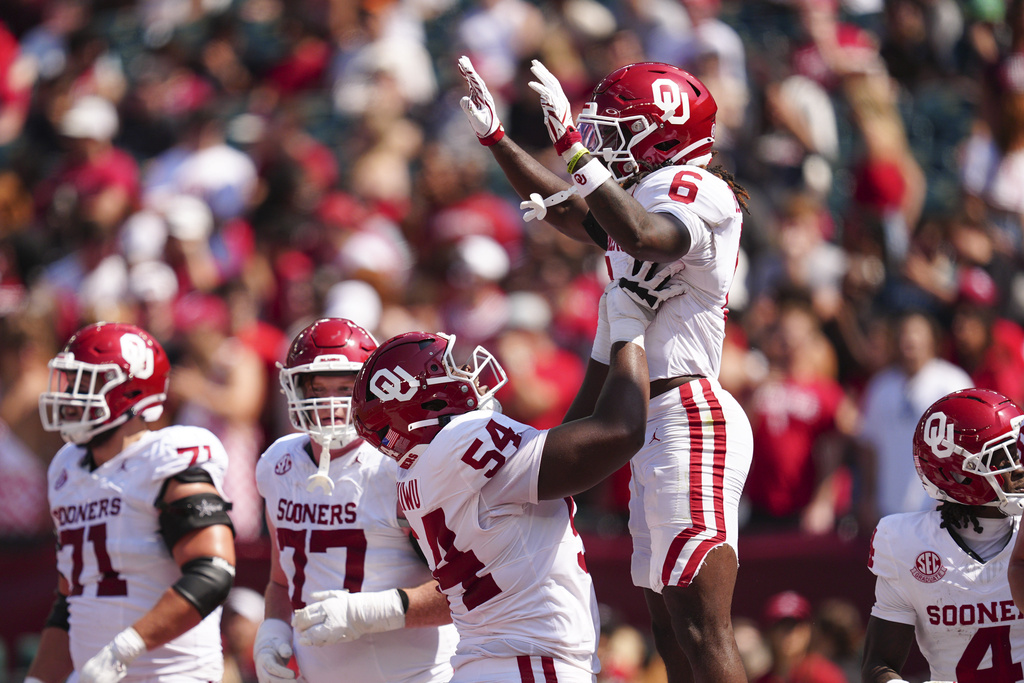Oklahoma running back Tory Blaylock (6) celebrates with Febechi Nwaiwu (54) after scoring a touchdown during the first half of an NCAA college football game against Temple, Saturday, Sept. 13, 2025, in Philadelphia. (AP Photo/Derik Hamilton)