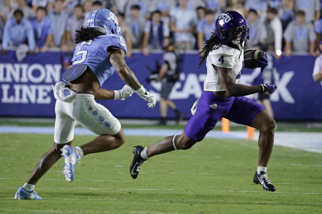 TCU wide receiver Jordyn Bailey (4) evades North Carolina defensive back Gavin Gibson (5) during the first half of an NCAA college football game Monday, Sept. 1, 2025, in Chapel Hill, N.C. (AP Photo/Chris Seward)