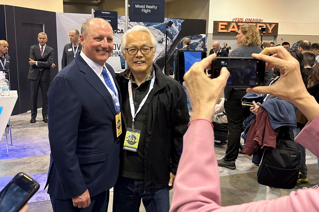FILE - Berkshire Hathaway Vice Chairman Greg Abel poses for pictures with shareholders while touring the booths Berkshires companies set up, May 3, 2024, in Omaha, Neb. (AP Photo/Josh Funk, File)