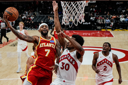 Atlanta Hawks guard Nickeil Alexander-Walker (7) shoots against Toronto Raptors guard Ochai Agbaji (30) during the second half of an NBA basketball game, Wednesday, Oct. 22, 2025, in Atlanta. (AP Photo/Mike Stewart) Atlanta Hawks guard Nickeil Alexander-Walker (7) shoots against Toronto Raptors guard Ochai Agbaji (30) during the second half of an NBA basketball game, Wednesday, Oct. 22, 2025, in Atlanta. (AP Photo/Mike Stewart)