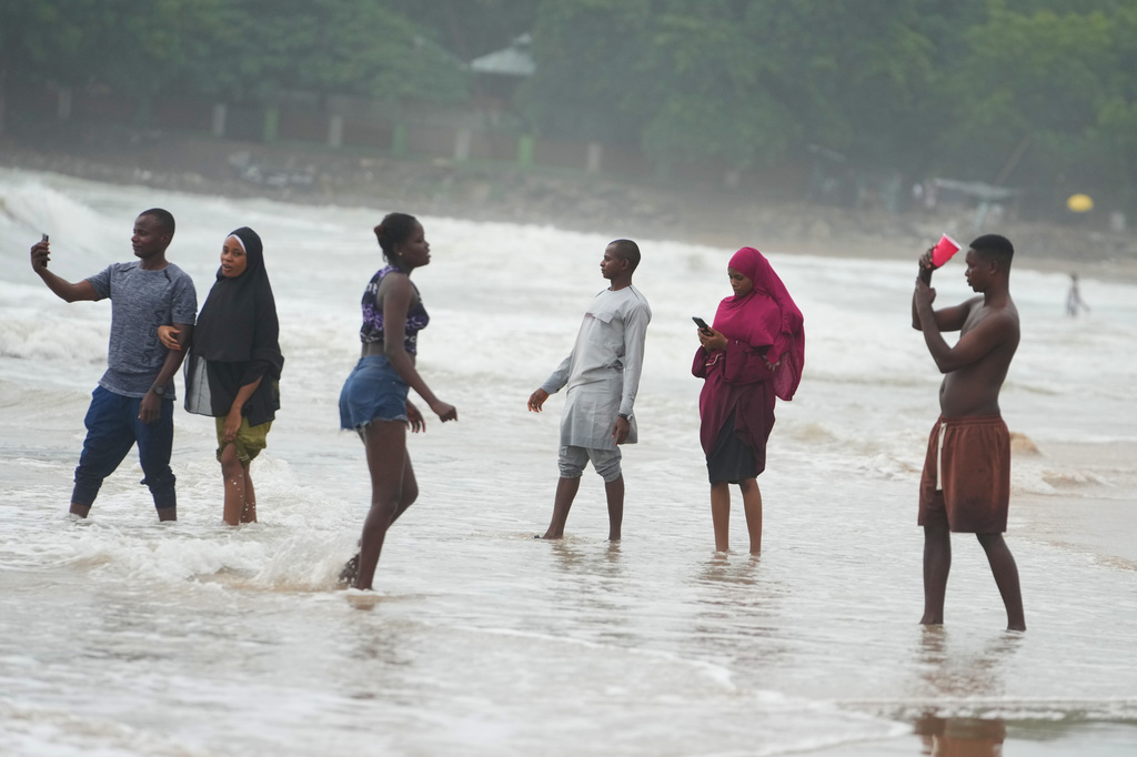 Beachgoers play at Takwa Bay beach in Lagos, Nigeria, Sunday, June 28, 2026. (AP Photo/Sunday Alamba)