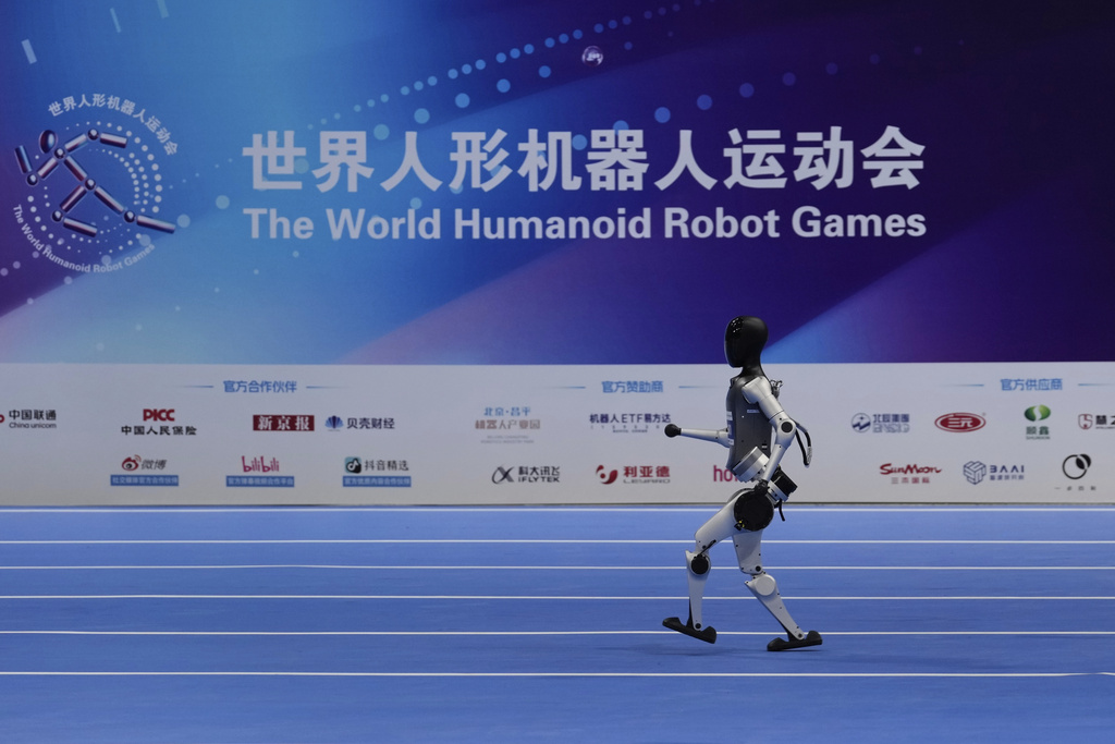 A robot competes in a race during the World Humanoid Robot Games in Beijing, China, Friday, Aug. 15, 2025. (AP Photo/Mahesh Kumar A.)