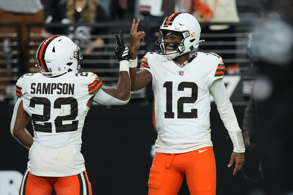 Cleveland Browns quarterback Shedeur Sanders (12) celebrates after throwing a touchdown pass to Cleveland Browns running back Dylan Sampson (22) against the Las Vegas Raiders during the second half of an NFL football game Sunday, Nov. 23, 2025, in Las Vegas. (AP Photo/Candice Ward)