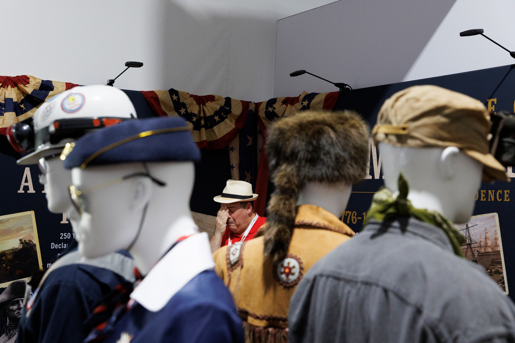 Kenneth Wolfe wipes his face after air conditioning failed inside the OSHA exhibit at the Great American State Fair on the National Mall, Thursday, July 2, 2026, in Washington. (AP Photo/Tom Brenner)