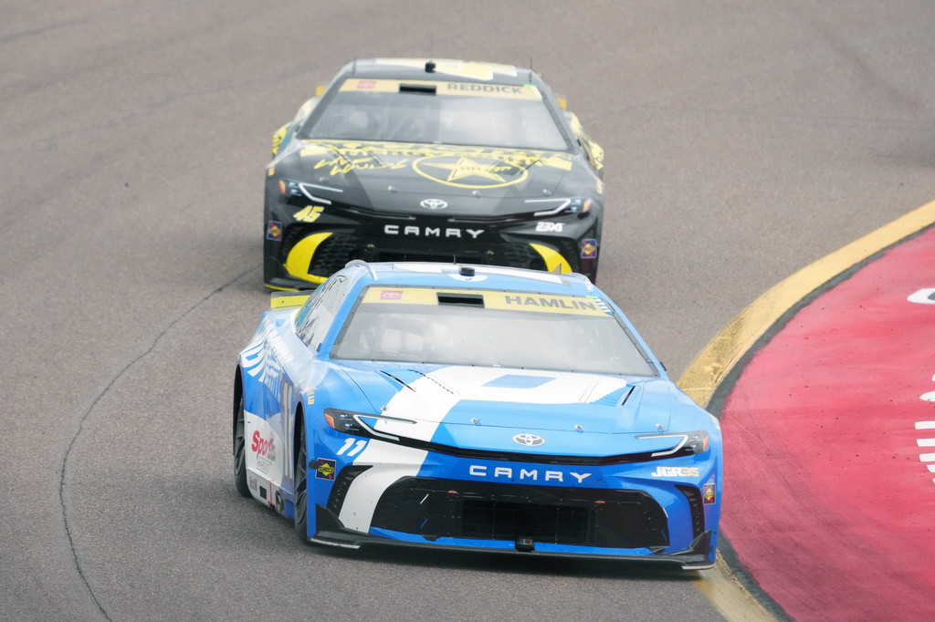 Denny Hamlin (11) leads Tyler Reddick on the 30th lap during a NASCAR Cup Series auto race Sunday, Oct. 18, 2026, in Avondale, Ariz. (AP Photo/Rick Scuteri)