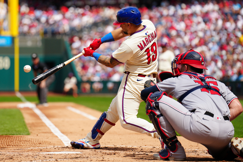 Philadelphia Phillies' Rafael Marchán hits a two run RBI double off Washington Nationals pitcher Jake Irvin during the second inning of a baseball game, Sunday, Aug. 24, 2025, in Philadelphia. (AP Photo/Derik Hamilton)