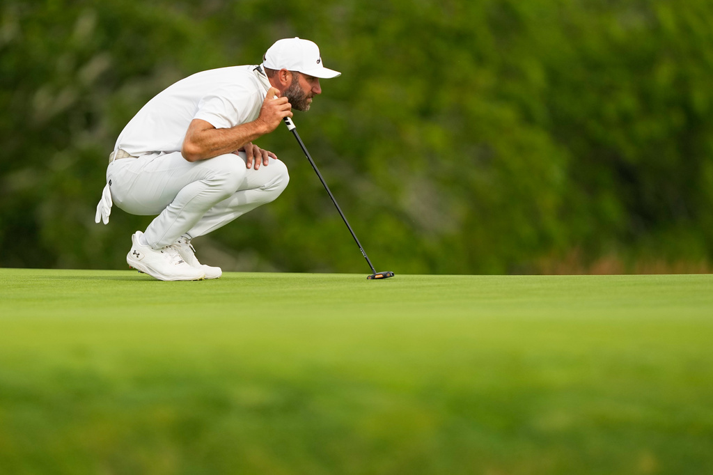 Dustin Johnson lines up a putt on the second hole during the second round of the U.S. Open golf tournament at Shinnecock Hills Golf Club in Southampton, N.Y., Friday, June 19, 2026.(AP Photo/Gerald Herbert)