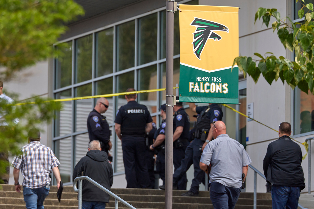 Tacoma Police officers investigate after multiple people were injured in a stabbing at Foss High School, Thursday, April 30, 2026, in Tacoma, Wash. (AP Photo/John Froschauer)