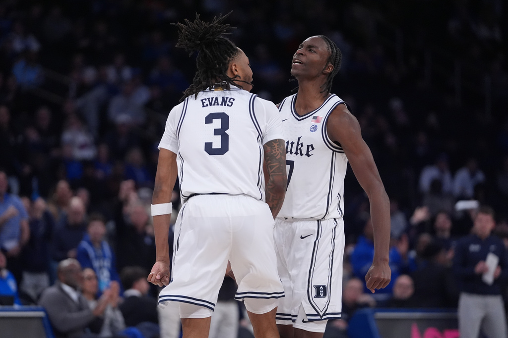 Duke's Dame Sarr (7) celebrates with Isaiah Evans (3) during the first half of an NCAA college basketball game against Kansas Tuesday, Nov. 18, 2025, in New York. (AP Photo/Frank Franklin II)