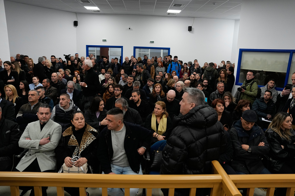 Relatives of victims of the Tempi train crash, waiting the the trial at the court in Larissa, Greece, Monday, March 23, 2026. (AP Photo/Thanassis Stavrakis)