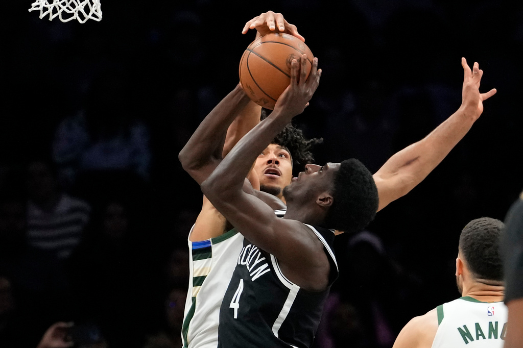 Milwaukee Bucks center Jericho Sims (00) blocks Brooklyn Nets guard Drake Powell (4) during the first half of an NBA basketball game, Tuesday, April 7, 2026, in New York. (AP Photo/Yuki Iwamura)