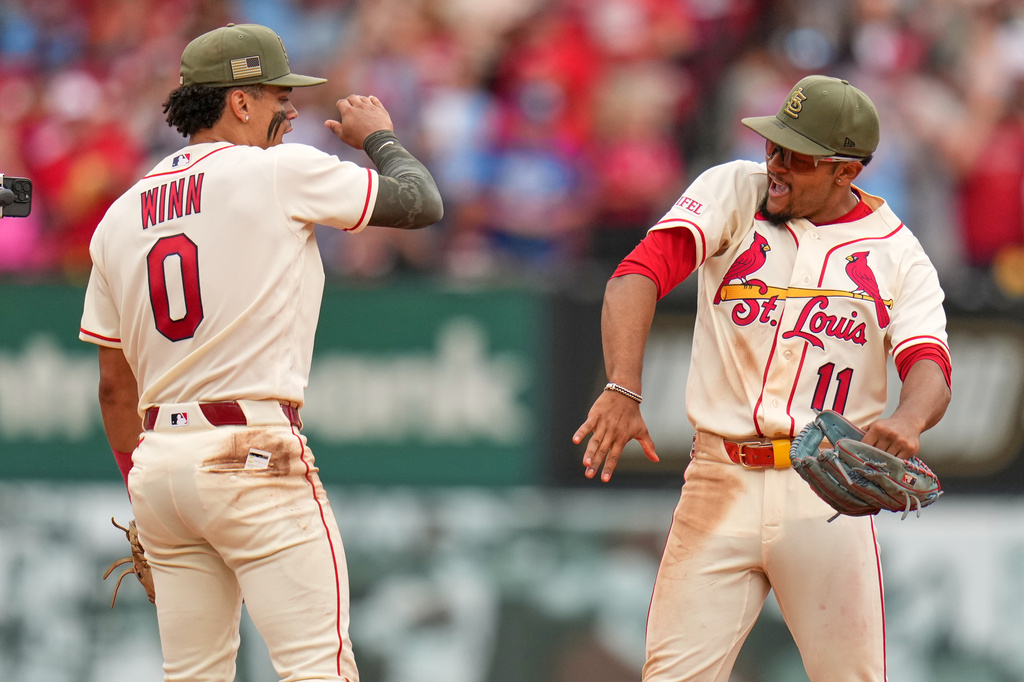 St. Louis Cardinals' Masyn Winn (0) and Victor Scott II (11) celebrate a victory over the Kansas City Royals in a baseball game Saturday, May 16, 2026, in St. Louis. (AP Photo/Jeff Roberson)