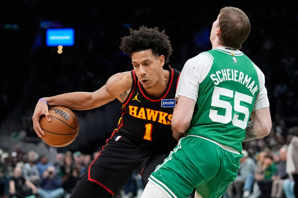 Atlanta Hawks forward Jalen Johnson (1) fouls Boston Celtics guard Baylor Scheierman (55) during the second half of an NBA basketball game, Wednesday, Jan. 28, 2026, in Boston. (AP Photo/Robert F. Bukaty)
