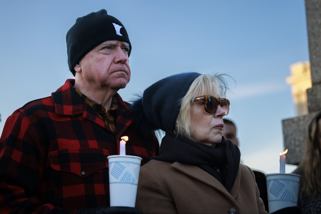 Minnesota Gov. Tim Walz and his wife, Gwen Walz, attend a vigil honoring Renee Good on Friday, Jan. 9, 2026, in St. Paul, Minn., outside the Minnesota State Capitol. (Kerem Yücel/Minnesota Public Radio via AP)