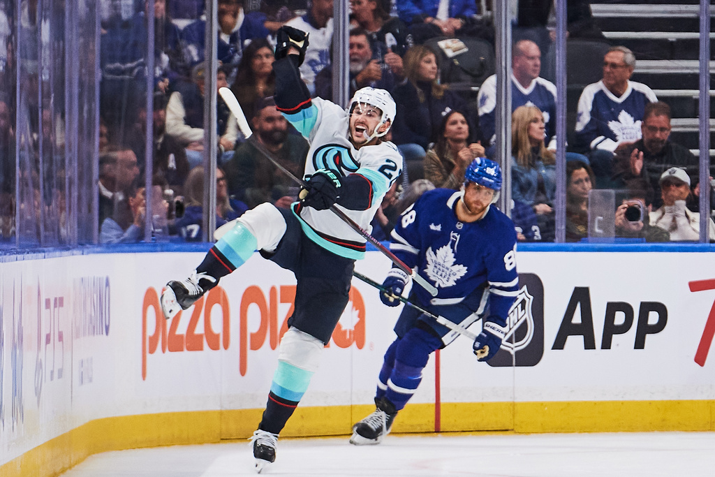 Seattle Kraken's Joshua Mahura (28) celebrates his game-winning goal against the Toronto Maple Leafs during an overtime NHL hockey game in Toronto on Saturday, Oct. 18, 2025. (Sammy Kogan/The Canadian Press via AP)