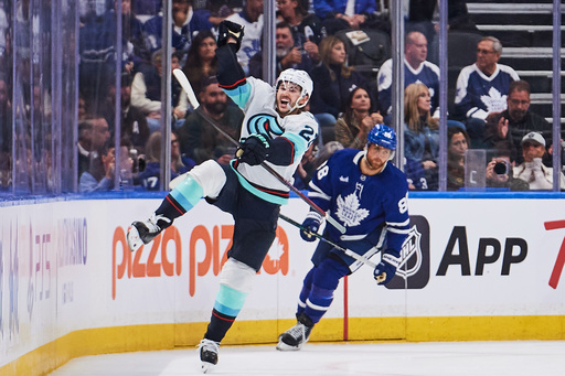 Seattle Kraken's Joshua Mahura (28) celebrates his game-winning goal against the Toronto Maple Leafs during an overtime NHL hockey game in Toronto on Saturday, Oct. 18, 2025. (Sammy Kogan/The Canadian Press via AP) Seattle Kraken's Joshua Mahura (28) celebrates his game-winning goal against the Toronto Maple Leafs during an overtime NHL hockey game in Toronto on Saturday, Oct. 18, 2025. (Sammy Kogan/The Canadian Press via AP)