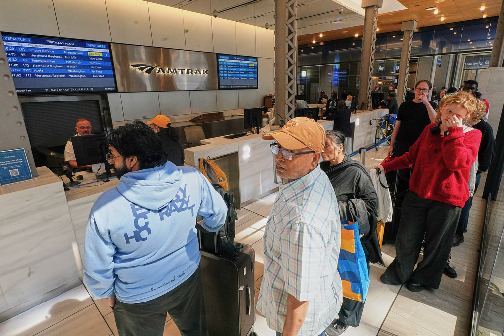 Amtrak passengers wait in the ticket office in New York's Penn Station, Friday, May 29, 2026. (AP Photo/Richard Drew)