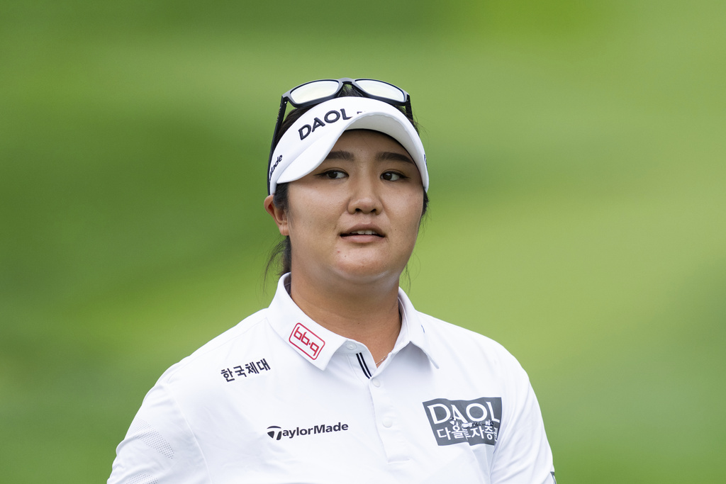 Haeran Ryu, of South Korea, looks towards the crowd after hitting off the first tee during the first round of the LPGA Portland Classic golf tournament at Columbia Edgewater in Portland, Ore., Thursday, Aug. 14, 2025. (AP Photo/Ali Gradischer)