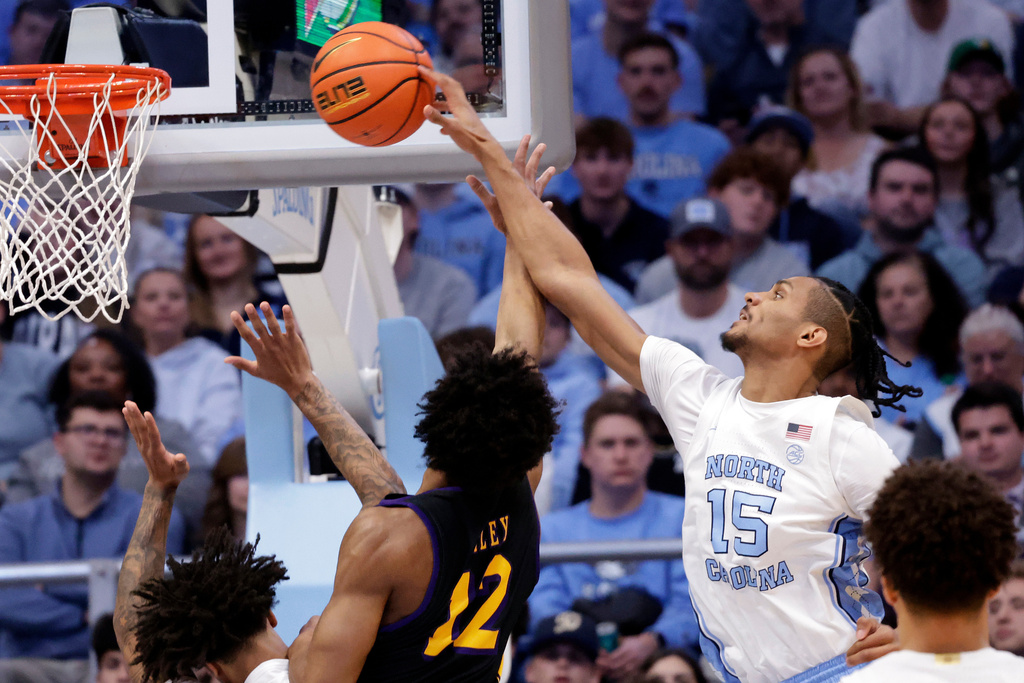 North Carolina forward Jarin Stevenson (15) goes up to block a shot by East Carolina guard Jordan Riley (12) during the first half of an NCAA college basketball game Monday, Dec. 22, 2025, in Chapel Hill, N.C. (AP Photo/Chris Seward)