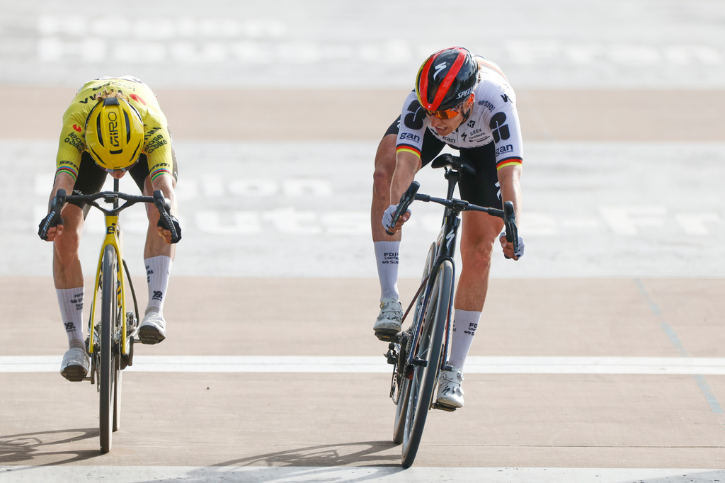 Franziska Koch of Germany, right, crosses the finish line ahead of Marianne Vos of the Netherlands to win the women's Paris-Roubaix Femmes cycling race in Roubaix, France, Sunday, April 12, 2026. (AP Photo/Jean-Francois Badias)