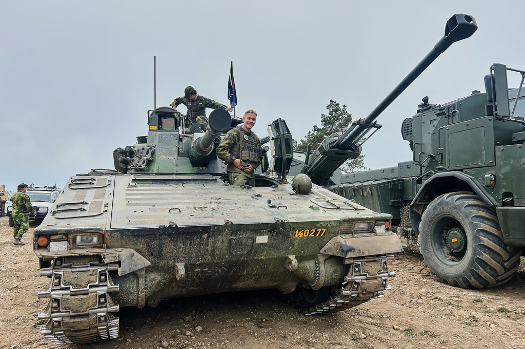 Swedish servicemen looks out of an armoured vehicle during a military exercises in Gotland, Sweden, Monday, May 11, 2026. (AP Photo/Emma Burrows)