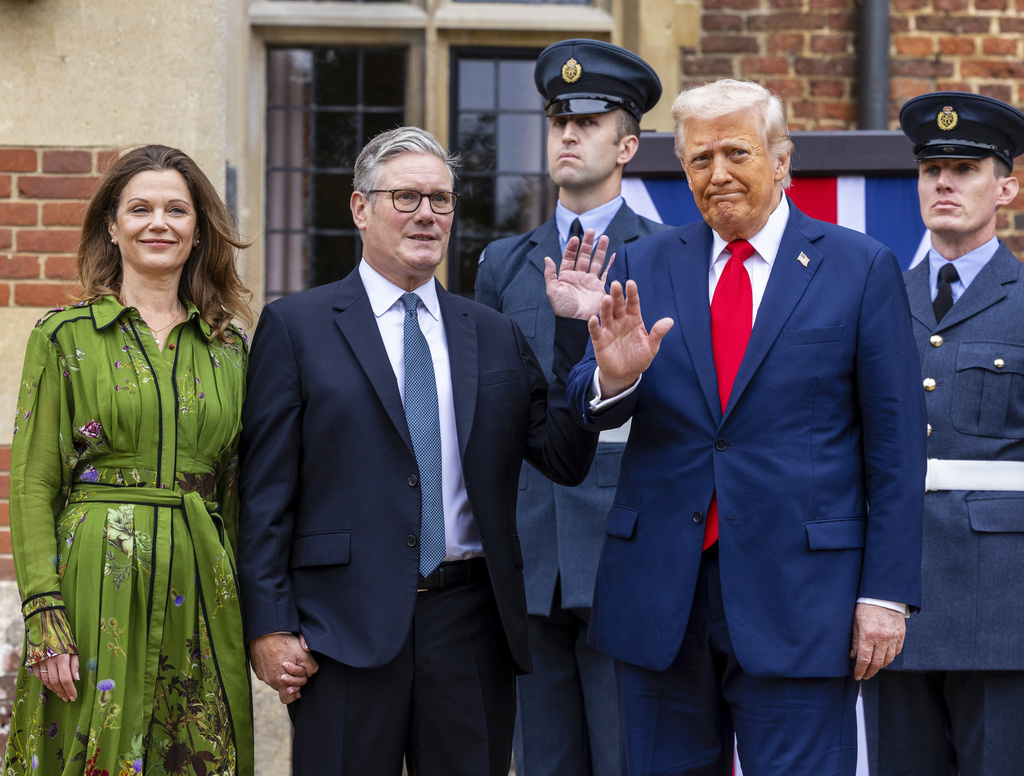President Donald Trump, foreground right is greeted by Britain's Prime Minister Keir Starmer and his wife Victoria, as he visits the prime minister's country residence Chequers, near Aylesbury, England, Thursday, Sept. 18, 2025. (Ian Vogler/Pool Photo via AP)