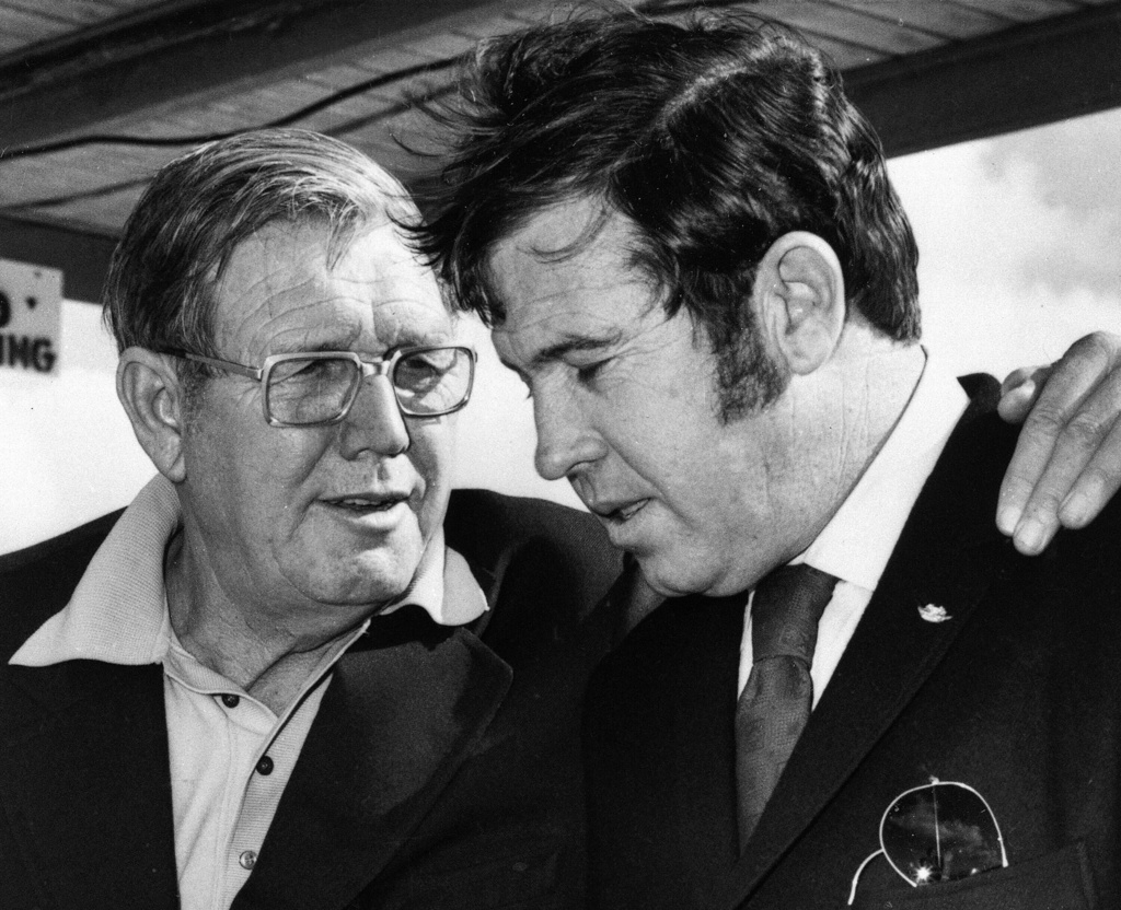 FILE - Bill France Sr., left, and son Bill France Jr. talk in Daytona Beach, Fla., Jan. 11, 1972. (AP Photo/File)